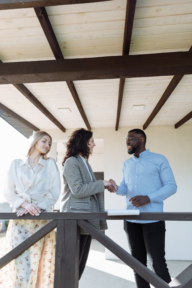 Real estate agent handing house keys to a smiling couple